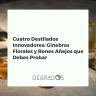 Cuatro botellas de destilados innovadores, dos de ginebra floral y dos de ron añejo, dispuestas elegantemente sobre mármol.